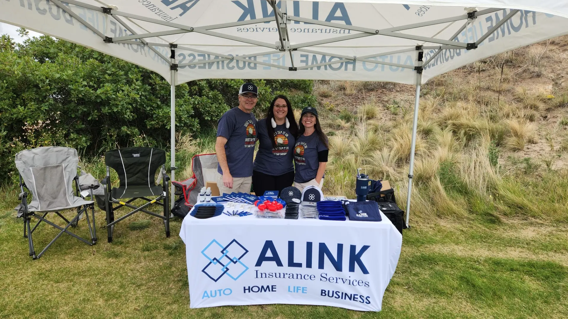 ALINK team at the Core Cup Umbrella Challenge booth.